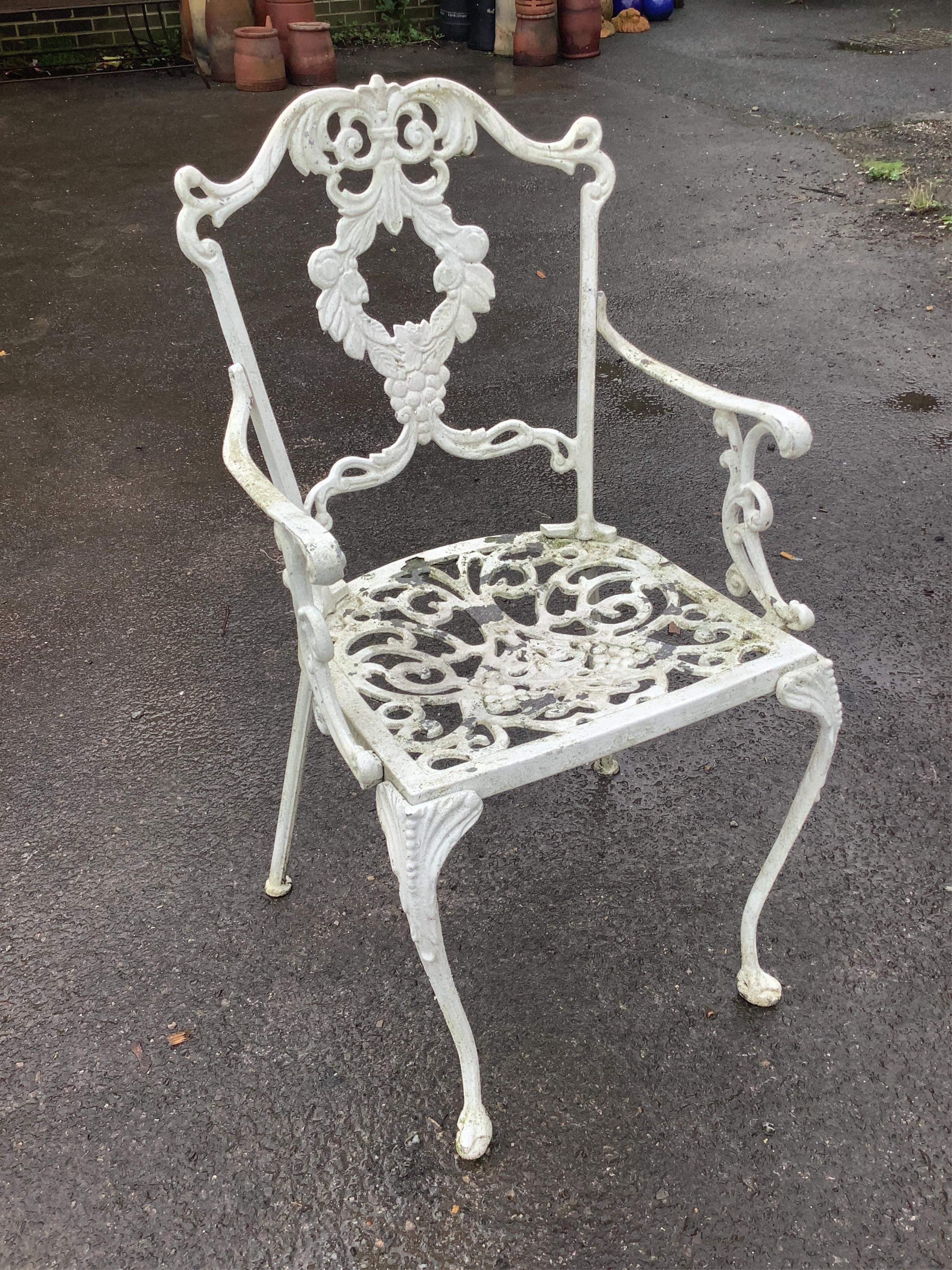 A Victorian style painted aluminium circular garden table, diameter 106cm, height 70cm and four chairs. Condition - good